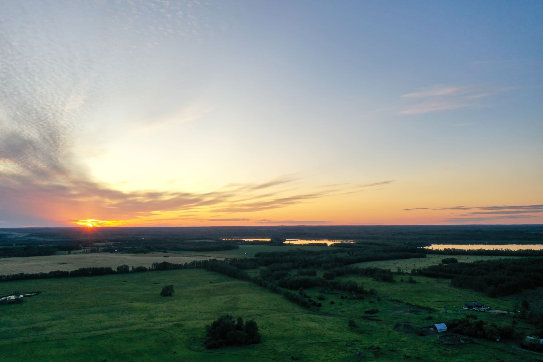 An aerial view of an acreage in Central Alberta during dawn.